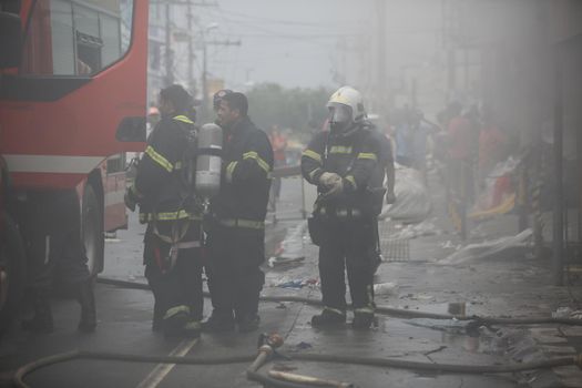 salvador, bahia, brazil - july 20, 2017: Members of the Fire Department firefighting the mattress factory in the city of Salvador.