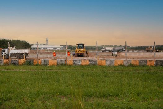 salvador, bahia, brazil - june 14, 2018: Workers and machines are seen during renovation work on the runway at the airport in the city of Salvador.