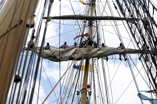 salvador, bahia, brazil - october 19, 2018: crew member of the Brazilian Navy's Cisne Branco are seen working on the vessel in the waters of the Todos os Santos Bay, in the city of Salvador.