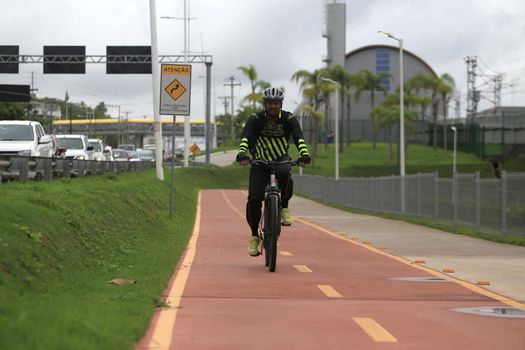 salvador, bahia, brazil - april 2, 2019: Person riding a bicycle on a bike path on Avenida Luiz Viana, along line 2 of the subway in the city of Salvador.