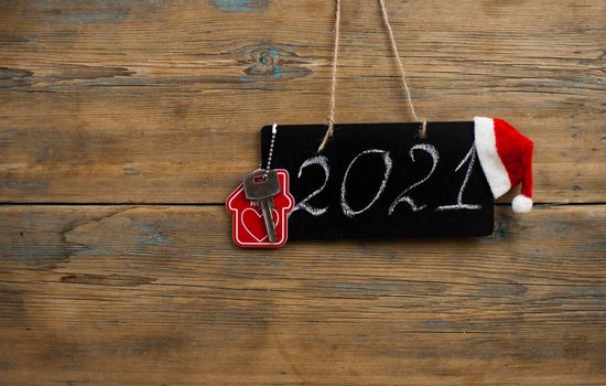 2021 - chalkboard with outlined text with red Santa hat - on wood