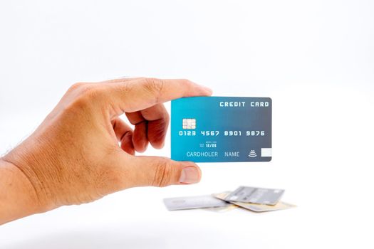 Human hand holding bank credit cards on white background.