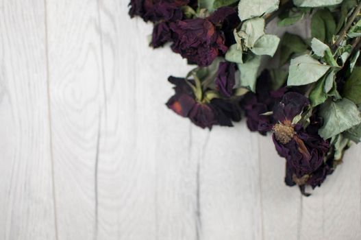 bouquet dried roses on wood background with copy space