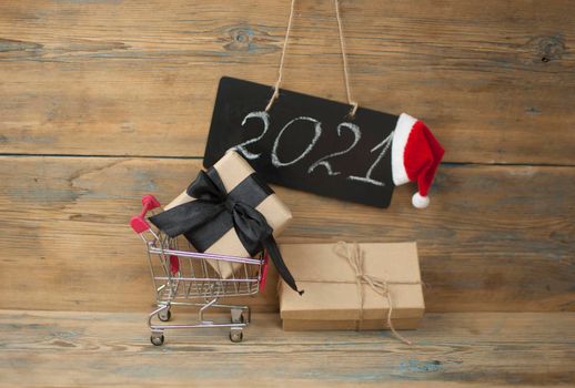 2021 - chalkboard with outlined text with red Santa hat - on wood