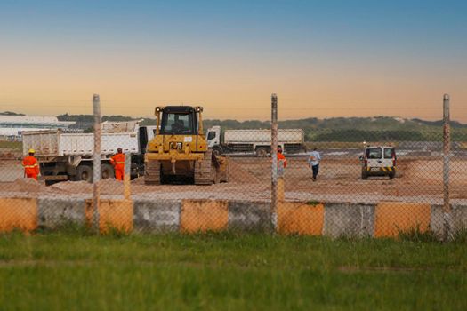 salvador, bahia, brazil - june 14, 2018: Workers and machines are seen during renovation work on the runway at the airport in the city of Salvador.