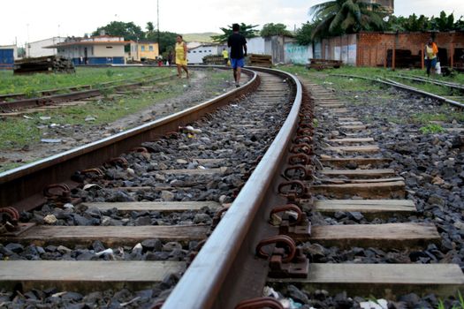 santo amaro, bahia / brazil - may 13 2017: people are seen walking near a train track in the city of Santo Amaro.
