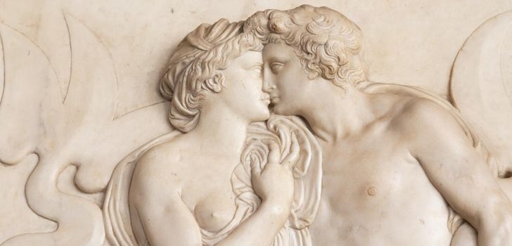 Ornamental relief of a fountain in Florence, Italy. Ancient sculpture with kissing couple. Florentine art 16th Cent.