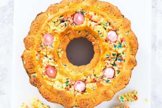 Creating holes for the buttercream filling in funfettti bundt cake.