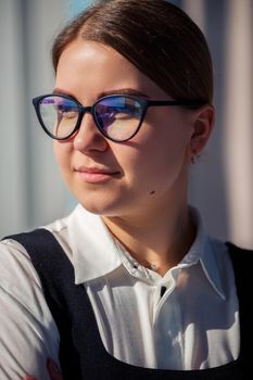 Confident business woman boss standing in modern office wearing glasses, female leader, business owner thinking about future success, planning new opportunities