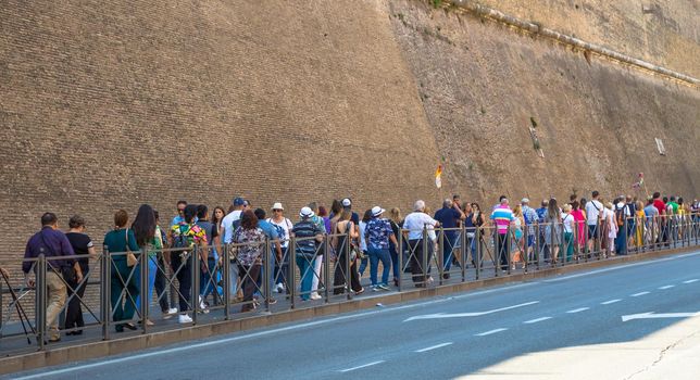 ROME, VATICAN STATE - AUGUST 24, 2018: people il line for the entrance to Vatican Museum in Rome. Concept for overtourism and mass-tourism.