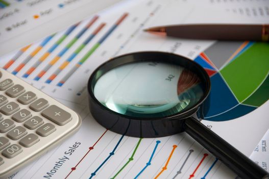 Magnifying glass on graph analysis. Copy space and business analysis concept.