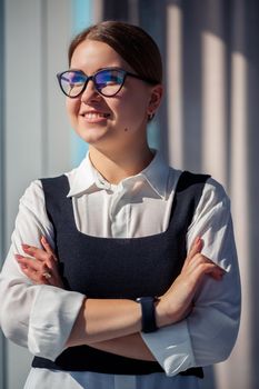 Confident business woman boss standing in modern office wearing glasses, female leader, business owner thinking about future success, planning new opportunities