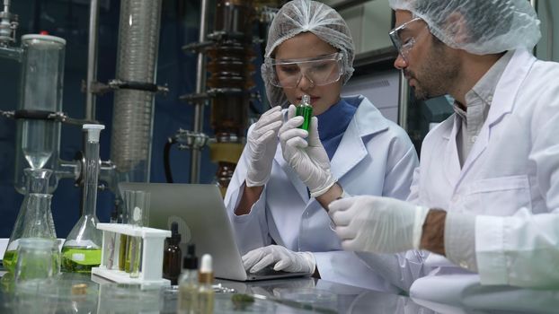 Two scientist in professional uniform working in laboratory for chemical and biomedical experiment