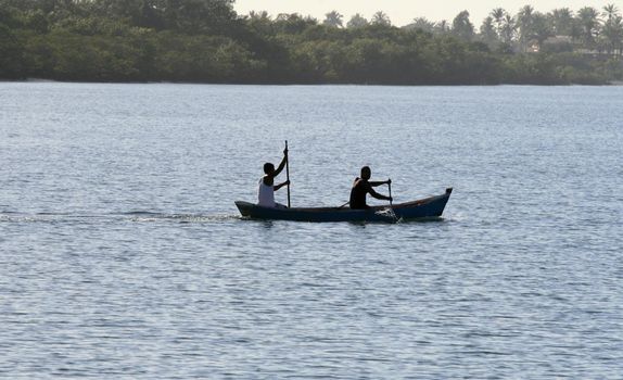 caravelas, bahia / brazil - september 11, 2008: people are seen in a rowboat in the waters of the Caravalas river in the city of Caravelas in southern Bahia.