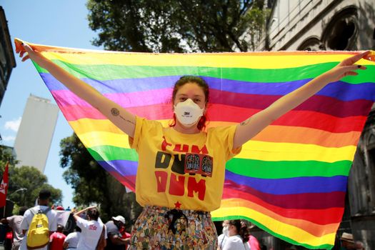 salvador, bahia, brazil - september 7, 2021: demonstrator carries gay pride flag during demonstration in Salvador city.