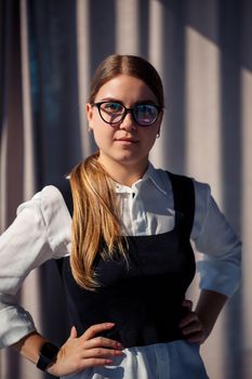 Confident business woman boss standing in modern office wearing glasses, female leader, business owner thinking about future success, planning new opportunities