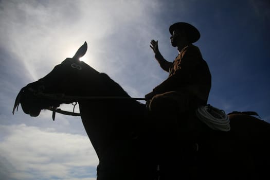 conde, bahia, brasil - january 8, 2022: Cowboy wearing traditional leather clothes with his horse on a farm in the city of Conde.
