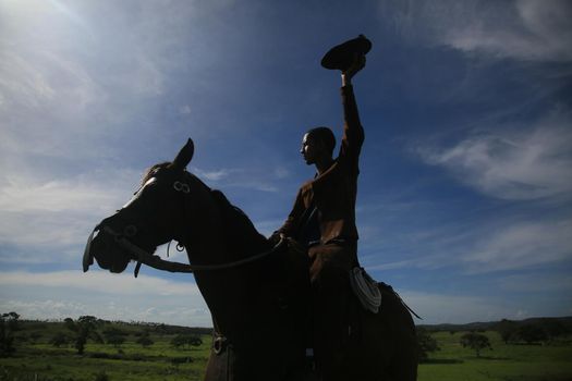 conde, bahia, brasil - january 8, 2022: Cowboy wearing traditional leather clothes with his horse on a farm in the city of Conde.