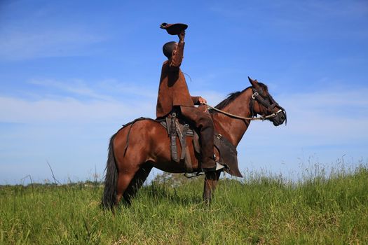 conde, bahia, brasil - january 8, 2022: Cowboy wearing traditional leather clothes with his horse on a farm in the city of Conde.