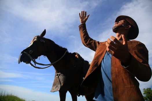 conde, bahia, brasil - january 8, 2022: Cowboy wearing traditional leather clothes with his horse on a farm in the city of Conde.