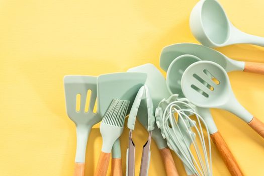 Flat lay. Silicone cooking utensils with wooden handle.