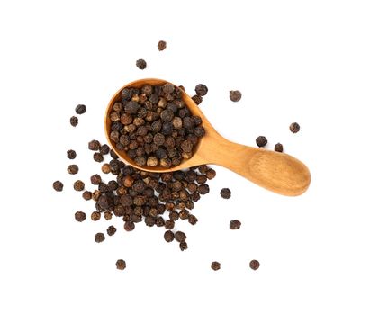 Close up one wooden scoop spoon full of black pepper peppercorns and heap of peppercorns spilled and spread around isolated on white background, elevated top view, directly above