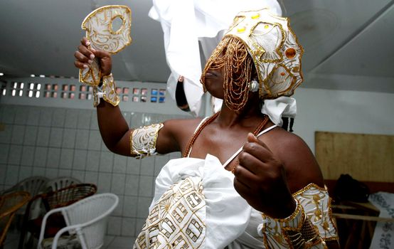 salvador, bahia / brazil - february 24, 2016: person wears the orixa Oxum, entity of Candomble, in the Brotas neighborhood in Salvador.


