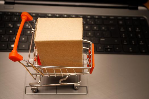 Online shopping illustration concept shot with miniature cart