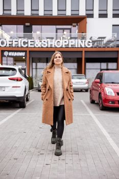 Beautiful stylish woman posing in fashionable clothes in leather shoes. Casual style. Urban fashion style. New collection of spring women's shoes