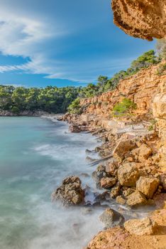 Cala Salada and Saladeta in san Antonio Abad at Balearic Islands Spain. Long exposure, Typical house for fishing boats and rocks.