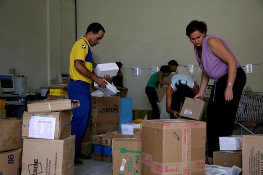 eunapolis, bahia / brazil - april 1, 2008: Correios employees sort orders for delivery in the city of Eunapolis, in southern Bahia.