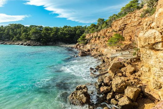 Cala Salada and Saladeta in san Antonio Abad at Balearic Islands Spain. Typical house for fishing boats and rocks.