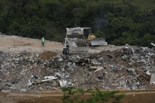 salvador, bahia / brazil - April 22, 2019: Truck is seen pouring rubble into landfill in Salvador. 

