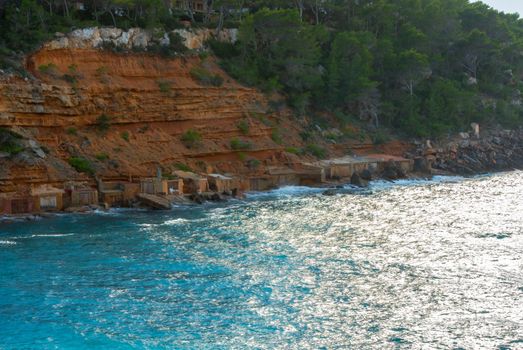 Cala Salada and Saladeta in san Antonio Abad at Balearic Islands Spain. Typical house for fishing boats and rocks.