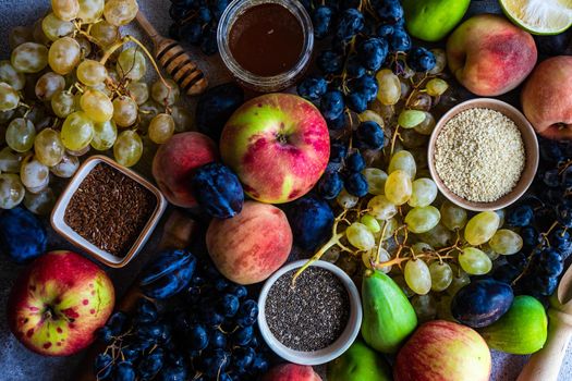 Variety of autumnal harvested fruits and berries qs a food background