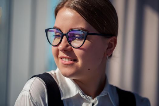 Confident business woman boss standing in modern office wearing glasses, female leader, business owner thinking about future success, planning new opportunities