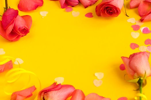 red roses flowers on yellow background, copy space. Banner , springtime concept, flyer, invitation traditional. template for designers. mockup. card with a rose petals and hearts on yellow background