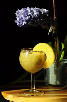 bright yellow breakfast smoothie with pineapple, kiwi and chia seeds on a dark background, healthy eating, still life, High quality photo