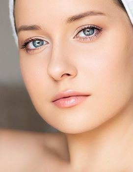 Skin care and beauty routine, beautiful woman with white towel wrapped around head, skincare cosmetics and face cosmetology, close-up portrait