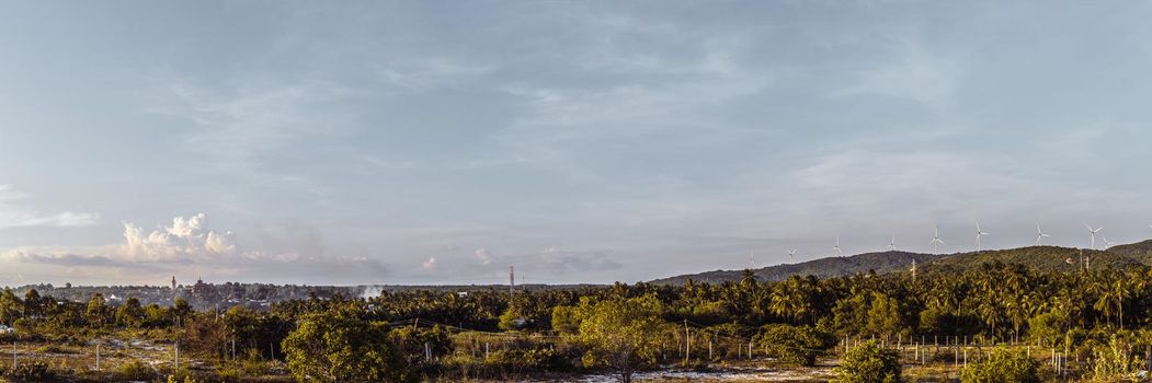 BANNER long format crop it, panorama summer landscape clouds buddhist temple statue windmills blue Sky Meditation background.