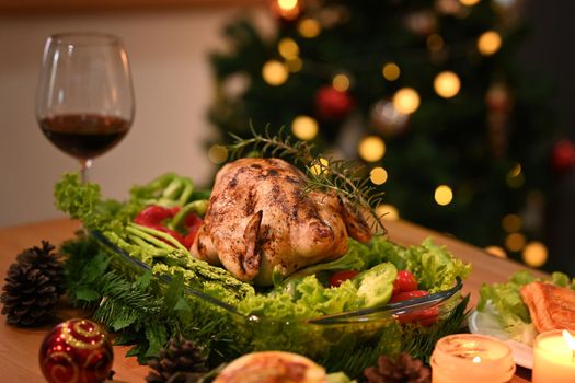 Thanksgiving table with baked turkey, glass of red wine and candle. Thanksgiving celebration traditional dinner concept.