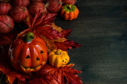 Autumnal flat lay with leaves and pumpkins on wooden background