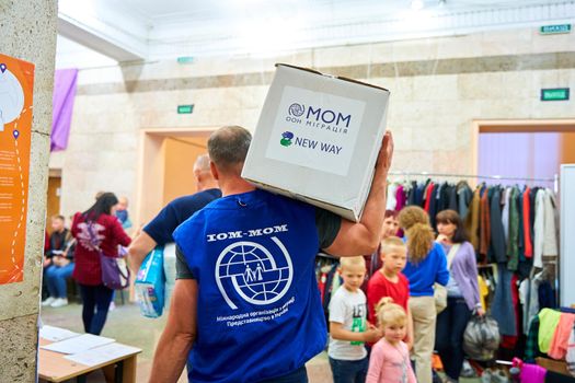 volunteer carrying a box with humanitarian aid. Dnipro, Ukraine - 06.30.2022