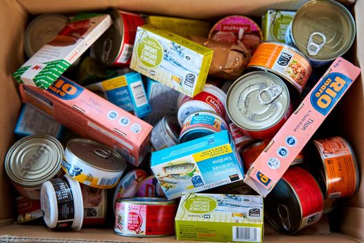 Paper box filled with canned food. Dnipro, Ukraine - 06.30.2022