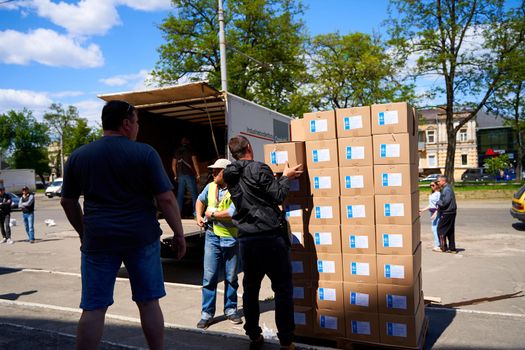 Ukrainian volunteers unloading boxes with humanitarian aid. Dnipro, Ukraine - 06.30.2022