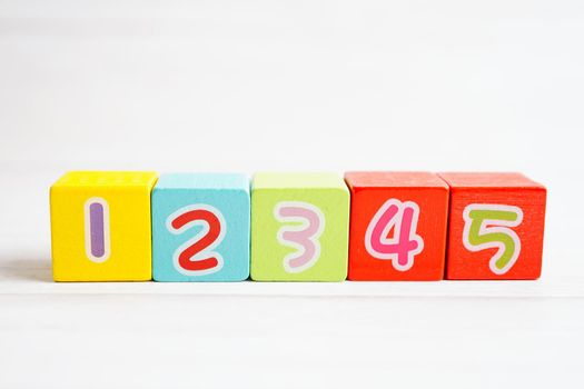 Number wood block cubes for learning Mathematic, education math concept.