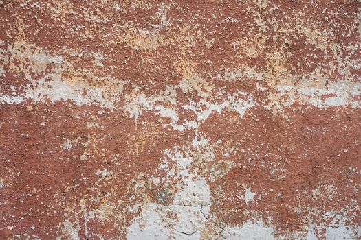 Brown peeled paint on old wall close up.