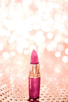 Cosmetic branding, sale and glamour concept - Pink lipstick on rose gold Christmas, New Years and Valentines Day holiday glitter background, make-up and cosmetics product for luxury beauty brand