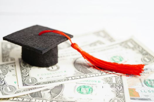 Graduation gap hat on US dollar banknotes money, Education study fee learning teach concept.
