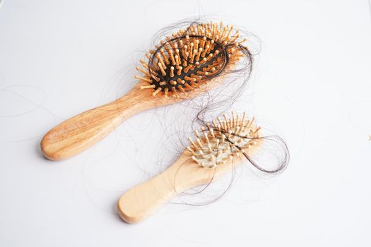Hair loss fall with comb brush isolated on white background.